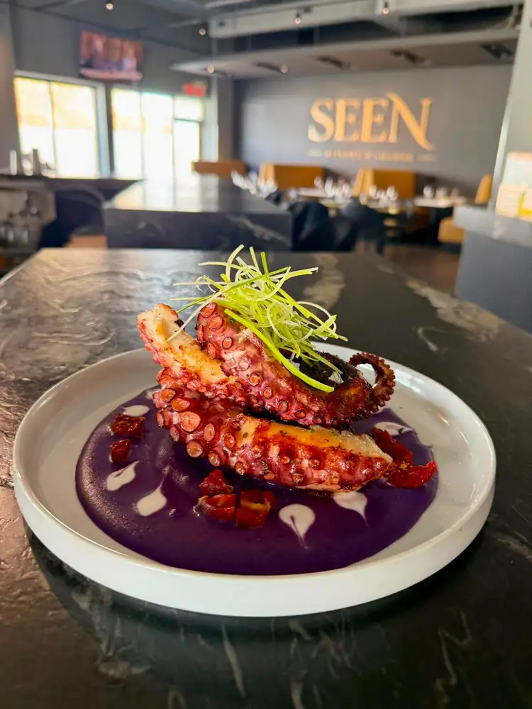 Signature chargrilled octopus plated at SEEN Kitchen & Lounge